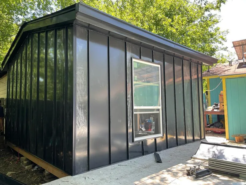 Black standing seam metal wall panels for Roof Inspection in Plainview