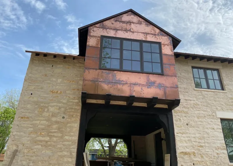 Copper metal panel facade on a stone building for Roof Repair in Plainview
